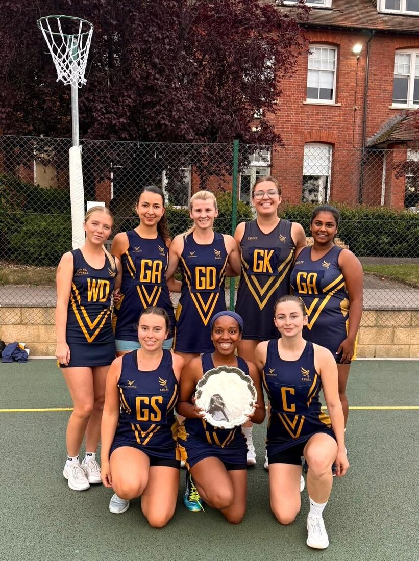 Eagles A with the Middlesex County Netball League Division 3 champions’ salver on a court